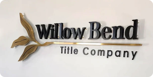 Elegant wall-mounted logo with gold leaf accent.